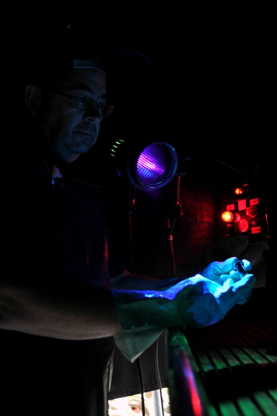Steve Starliper, 89th Maintenance Group non-destructive inspection technician, performs a magnetic-particle inspection on an aircraft part here Jan. 24. The inspection is used on ferrous metals to create a magnetic field around cracks. (U.S. Air Force Photo/Senior Airman Perry Aston)
