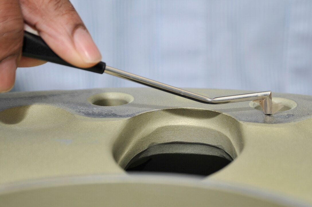 Patrick Cole, 89th Maintenance Group lead non-destructive inspection technician, inspects a VC-25A (Air Force One) aircraft main landing gear wheel, for cracks using an eddy-current tester Jan. 24. Non-destructive inspection technicians inspect the wheels of Andrews's aircraft after each tire change. (U.S. Air Force Photo by Senior Airman Perry Aston)