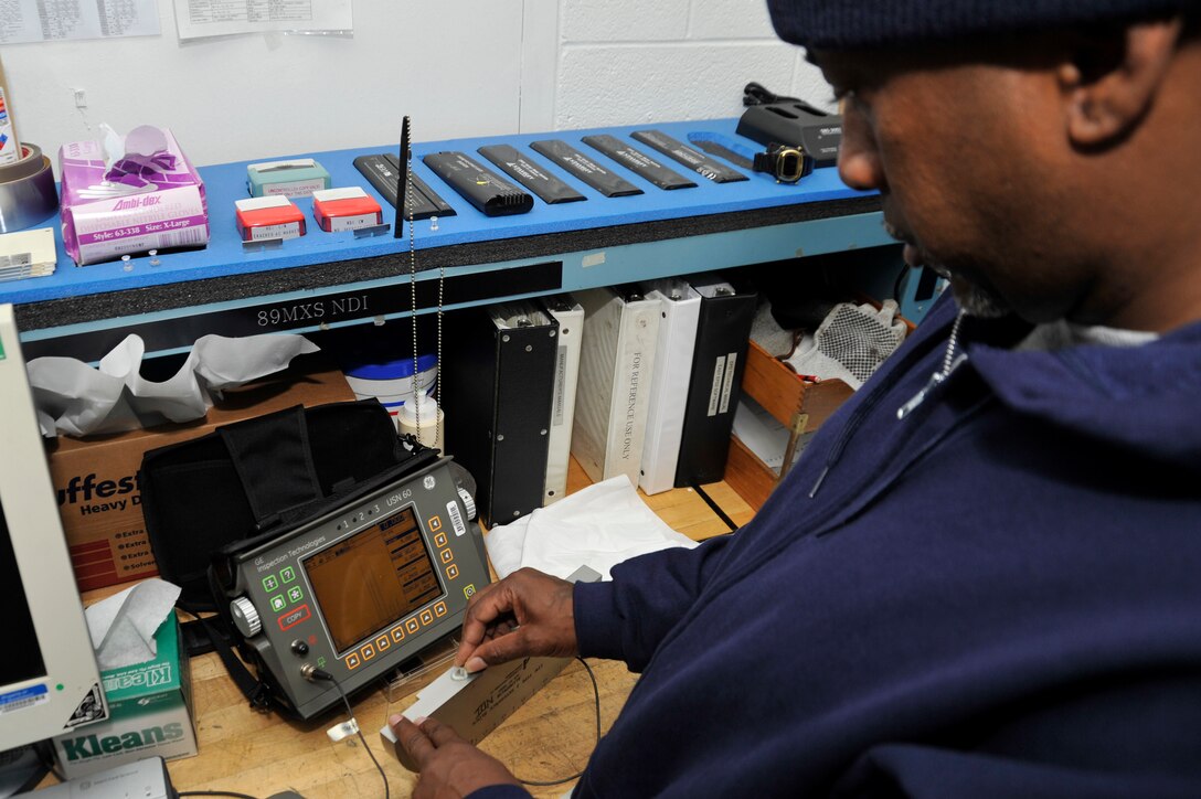Ethan Watson, 89th Maintenance Group non-destructive inspection technician, calibrates an ultrasound inspection machine Jan. 24 here. Non-destructive technicians use a wide array of analysis techniques when evaluating the properties of aircraft materials, components and systems. Each technique causes zero damage to machine parts. (U.S. Air Force Photo/Senior Airman Perry Aston)