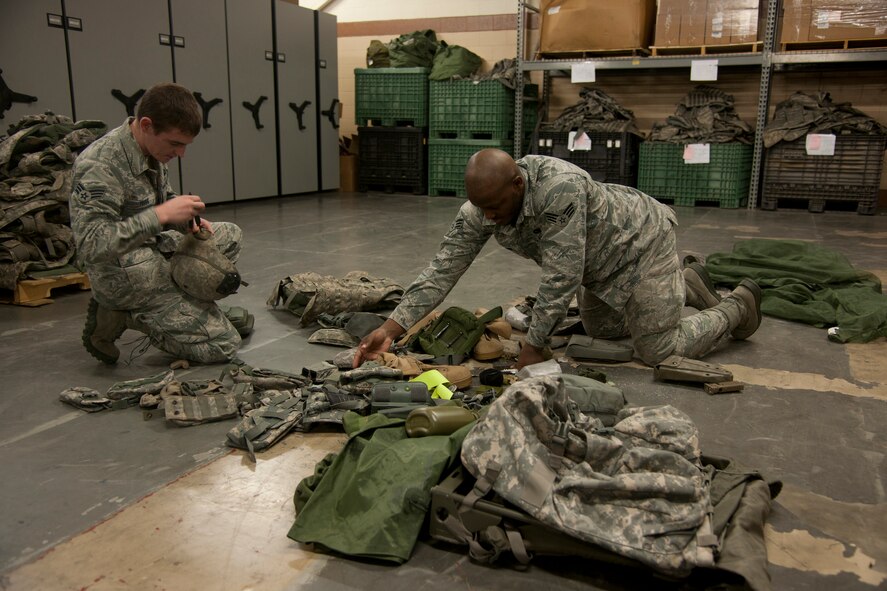 U.S. Air Force Senior Airmen Marcus Heyward and Edward Young, 820th Combat Operations Squadron security forces, sort equipment at Moody Air Force Base, Ga., Jan. 19, 2012. The unit can spend up to a day conducting inventory and storing the gear once it’s received. (U.S. Air Force Photo by Airmen 1st Class Paul Francis/Released) 
