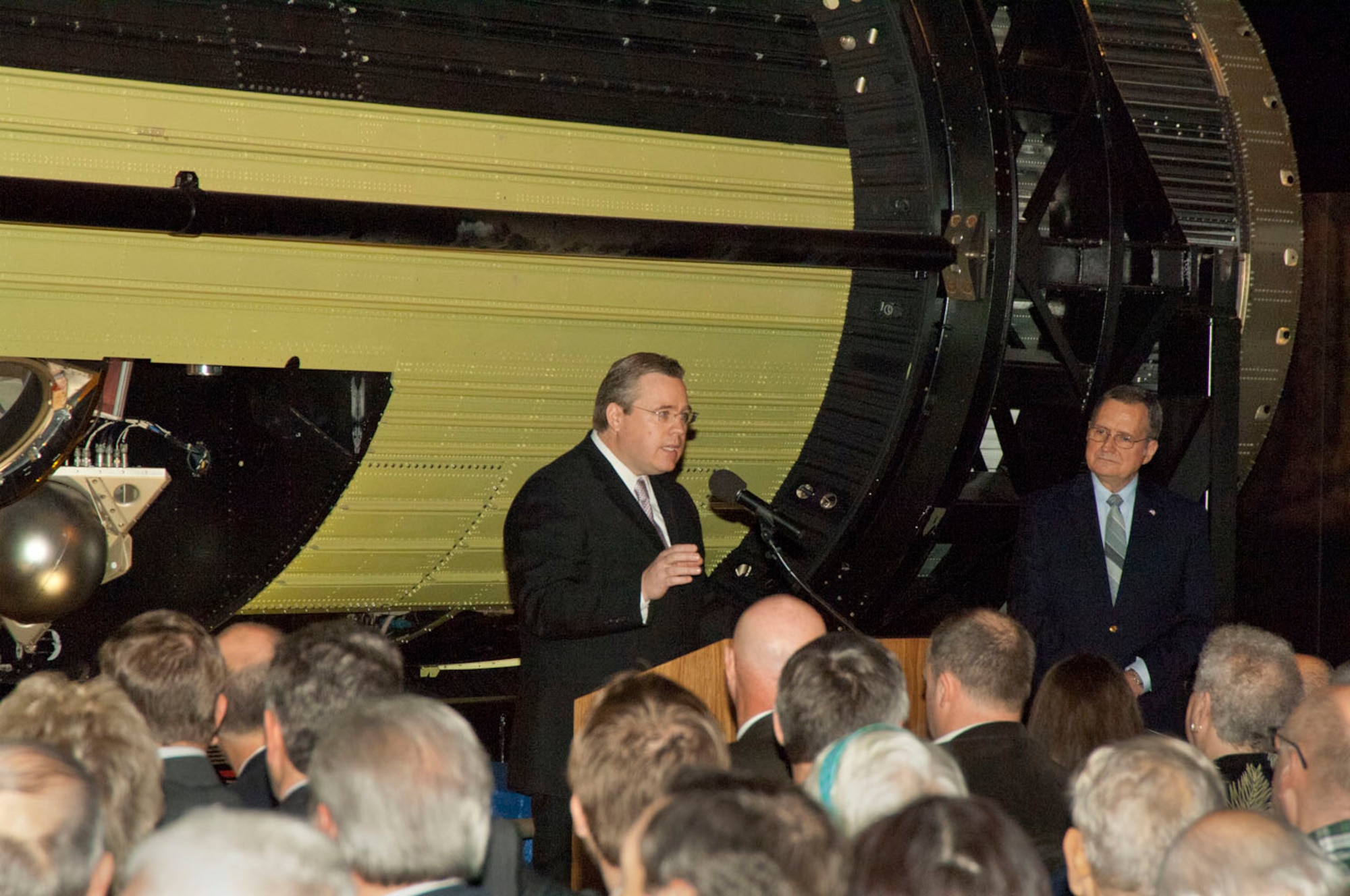 DAYTON, Ohio -- National Reconnaissance Office Historian Dr. James Outzen speaks during the exhibit opening of three formerly classified reconnaissance satellites - Gambit 1 KH-7, Gambit 3 KH-8 and Hexagon KH-9 - at the National Museum of the U.S. Air Force.  (U.S. Air Force Photo)