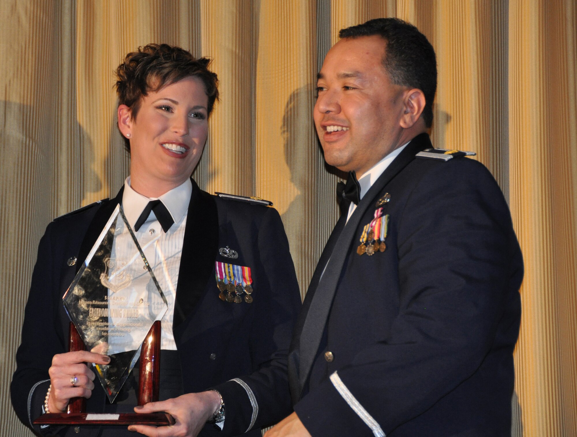 JOINT BASE MCGUIRE-DIX-LAKEHURST, N.J. -- Majors Kerri Ebrecht and Jose Delgado, (from left), commanders of the 514th Aircraft Maintenance and 514th Maintenance Squadrons, respectively, share the limelight after both garner first place for the Freedom Wing squadron level awards at the 514th Air Mobility Wing Annual Awards Banquet held Jan. 21 at the Community Center, here. (U.S. Air Force photo/Master Sgt. Donna T. Jeffries)