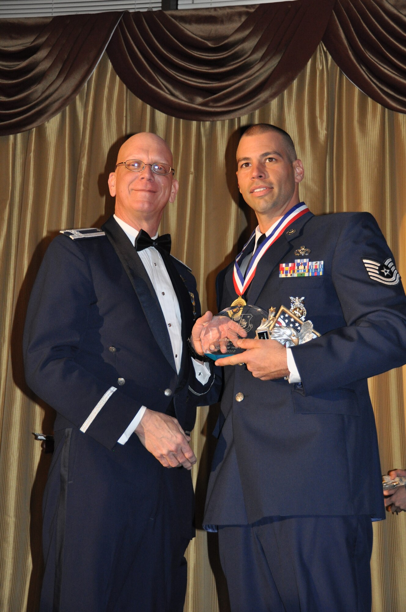 JOINT BASE MCGUIRE-DIX-LAKEHURST, N.J. - Tech. Sgt. Gregory Dicembri, right, of the 514th Civil Engineer Squadron is named the 514th Air Mobility Wing Noncommissioned Officer of the Year 2011. Col. Michael Underkofler, commander, 514th AMW presented annual awards to 14 recipients during the wing's annual award banquet held Jan. 21 at the Community Center, here. (U.S. Air Force photo/Master Sgt. Donna T. Jeffries)