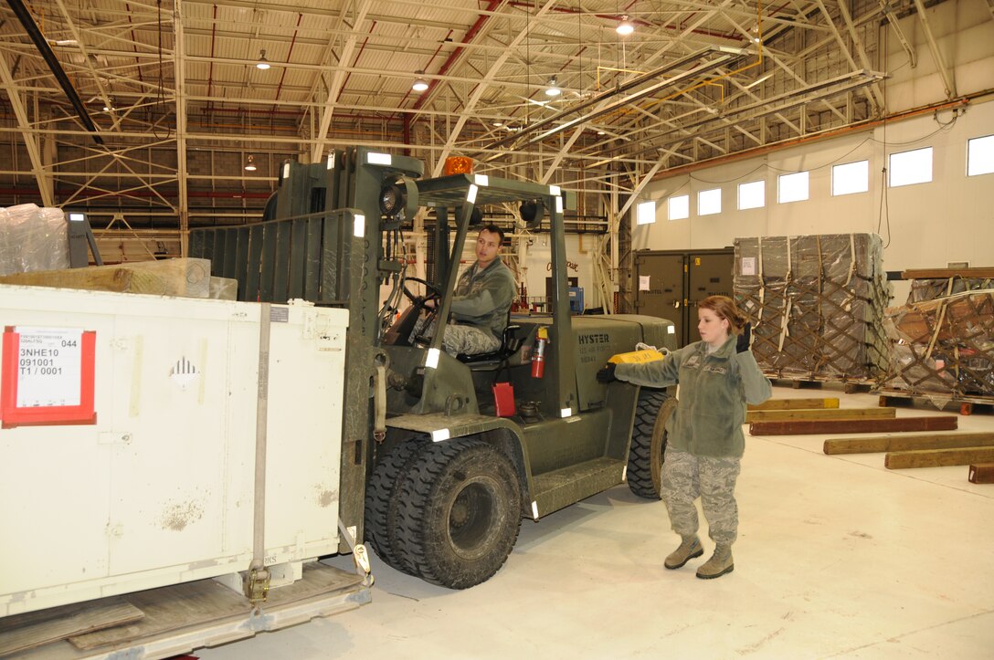 Senior Airman Joshua Strange and Airman 1st Class Cierra Edwards of the 107th Airlift Wing's Aerial Port move cargo in the holding area for the next phase in shipping. The 107th and 914th Airlift Wing's had their Position the Force Exercise at the Niagara Falls Reserve Station Jan 21 2012(Air Force Photo/Senior Master Sgt. Ray Lloyd)

