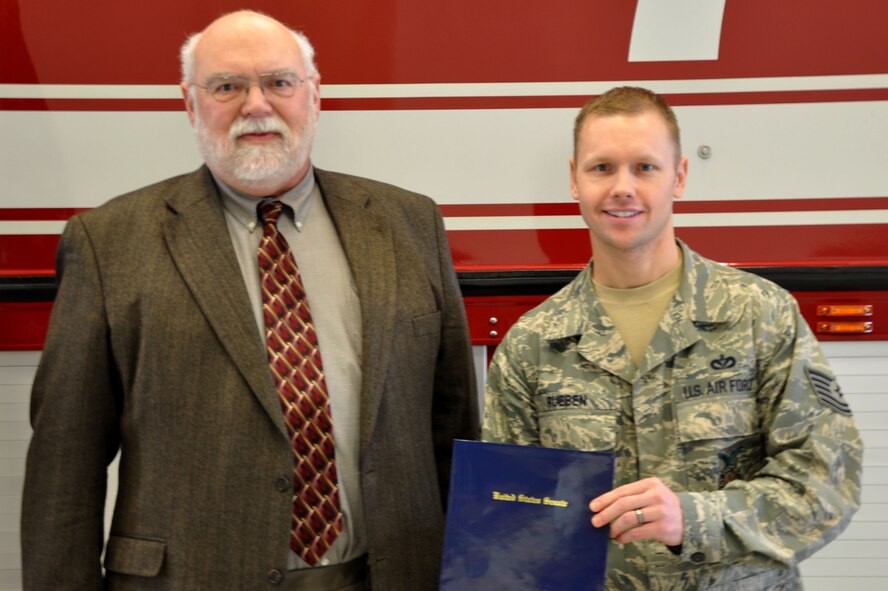 Tech. Sgt. Jeffery Rueben, 319th CIvil Engineer Squadron, poses with State Representative Jim Hand of Sen. Kent Conrad's office Jan. 25 on Grand Forks Air Force Base. Rueben was presented the National Firefighters Public Servant Award for the state of Nort Dakota during a ceremony at the base fire station. (U.S. Air Force photo/Airman 1st Class Derek VanHorn)