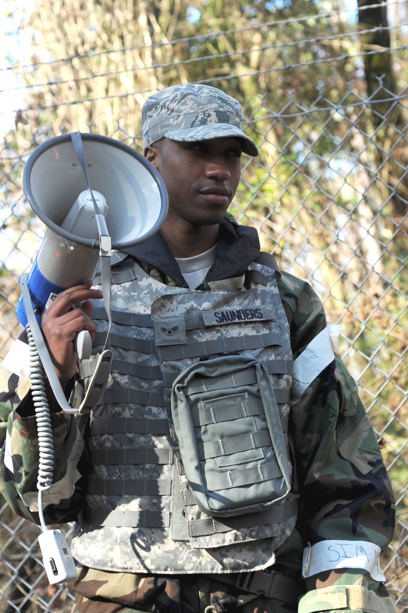 Airman 1st Class Myron Saunders sirens the bull horn to simulate alarm red during Ability to Survive and Operate Rodeo training on Seymour Johnson Air Force Base, N.C., Jan. 25, 2012. The ATSO Rodeo evaluates Airmen on their Mission Oriented Protective Posture gear wear, contamination avoidance, transition and post attack responses, self aid buddy care skills in a contaminated area and contamination control abilities. Saunders is a 4th Civil Engineer Squadron emergency management journeyman from High Point, N.C. (U.S. Air Force photo/Senior Airman Whitney Stanfield)  