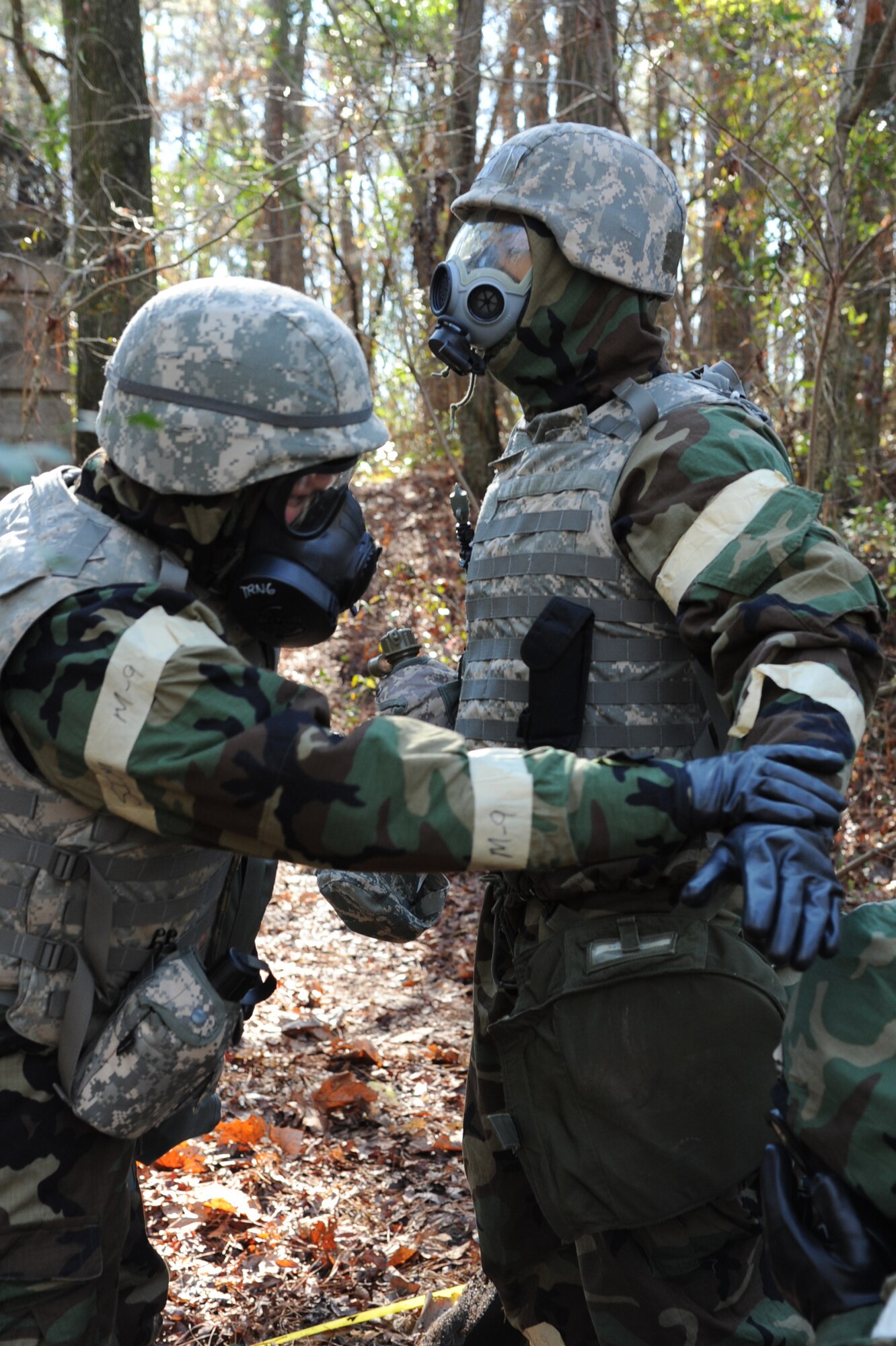 Airman 1st Class Kyle Glenn performs a buddy check on Senior Airman Terence Stewart during Ability to Survive and Operate Rodeo training on Seymour Johnson Air Force Base, N.C., Jan. 25, 2012. When performing a buddy check Airmen secure all uniform openings to ensure no airborne agents seep through and affect the Airman’s health. Glenn is a 4th Civil Engineer Squadron water and fuel systems maintainer from Spruce Pine, N.C. Stewart is a 4th CES house management journeyman from Wayne, Mich. (U.S. Air Force photo/Senior Airman Whitney Stanfield)  