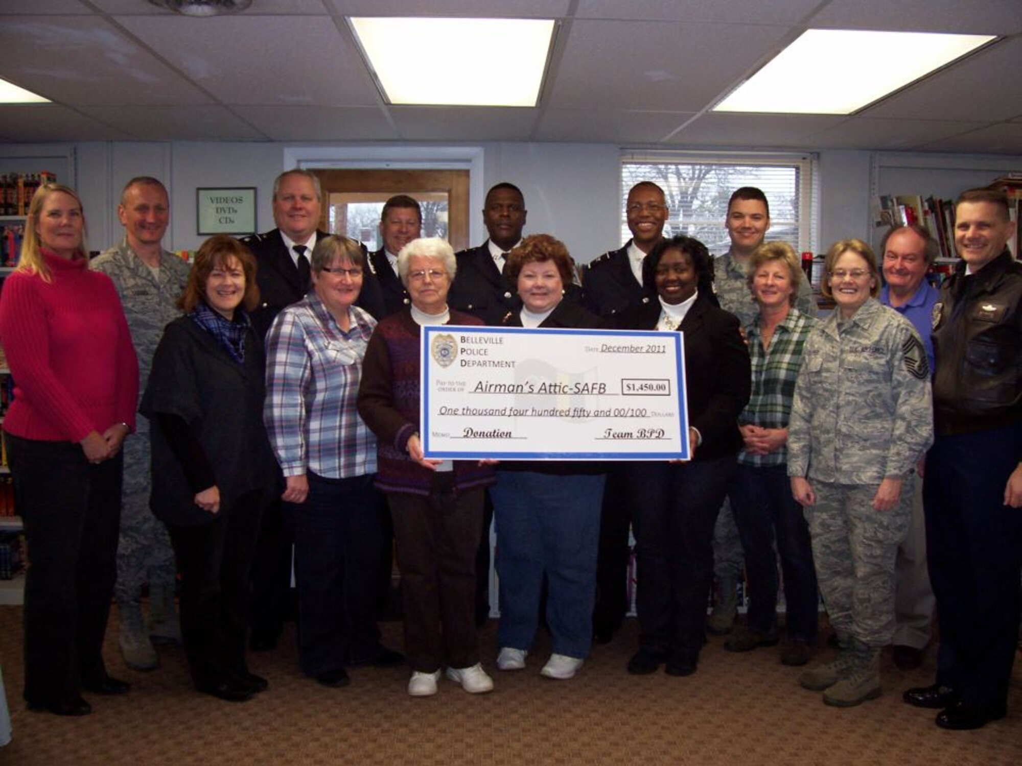 The Airman’s Attic receives a check from the Belleville Police Department Jan. 20, 2012. The Belleville Police Department raised $1,450 for the Airman’s Attic. (U.S. Air Force photo/Christine Spargur) 