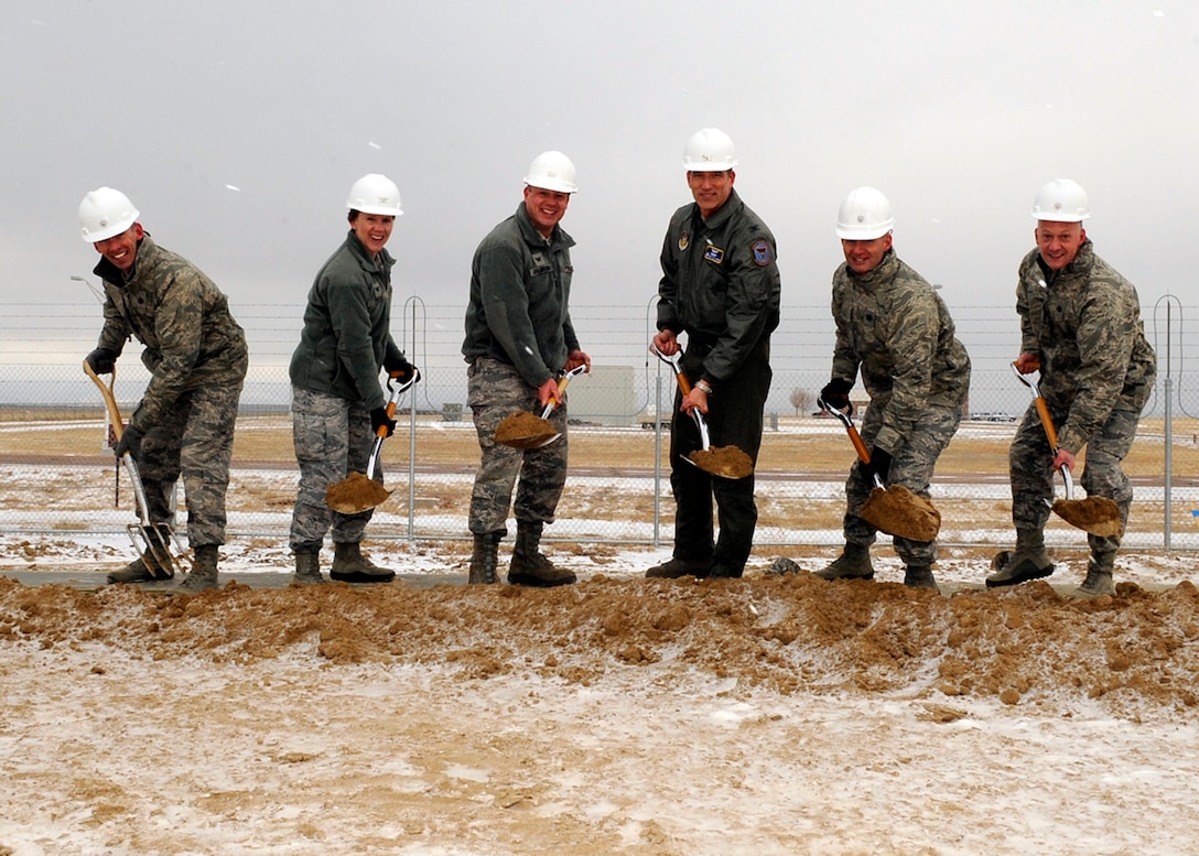 PETERSON AIR FORCE BASE, Colo. -- The 16th Space Control Squadron and 380th Space Control Squadron, a Reserve Associate Unit, broke ground near the east gate Jan. 17 for a new RAIDRS space control facility. Turning the first ceremonial shovel of earth is (left to right) Lt. Col. Roger Sherman, 16th SPCS commander; Col. Jennifer Moore, 21st Operations Group commander; Col. Chris Crawford, 21st Space Wing commander; Col. Jeff Mineo, 310th SW commander; Lt. Col. Traci Keuker-Murphy, 310th OG commander; and Lt. Col. Robert Claude, 380th SPCS commander. (U.S. Air Force photo/Rob Bussard)