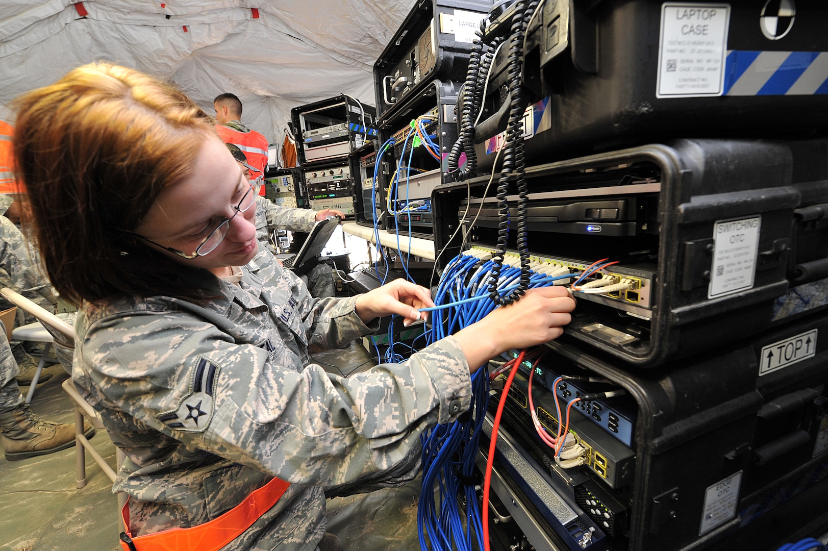 SAVANNAH AIR NATIONAL GUARD BASE, Ga. – Airman 1st Class Khrysta Neal, a 52nd Combat Communications Squadron cyber surety apprentice, installs a cable on the a router that is part of the initial communications element system, designed to deliver NIPRNET, SIPRNET, and secure/non-secure voice communications to bare-base deployed locations, here Jan. 24. The unit began its Arctic Gator field training exercise Jan. 24 and will build, operate in and defend a fully functioning bare base communications camp before the exercise ends Feb. 3. (U.S. Air Force photo by Tommie Horton)