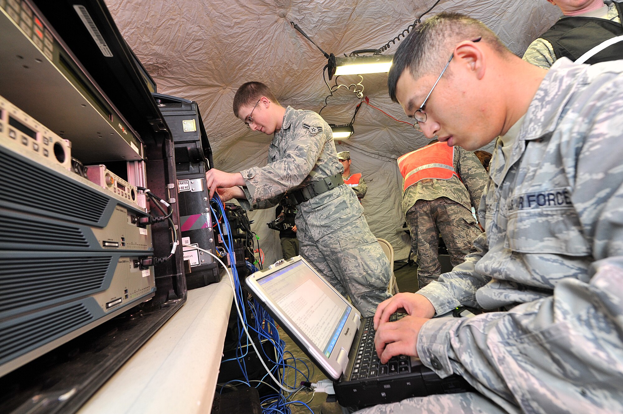 SAVANNAH AIR NATIONAL GUARD BASE, Ga. – Staff Sgt. David Harris and Airman 1st Class Nathaniel Osborn, 52nd Combat Communications Squadron, configure the initial communications element system, designed to deliver NIPRNET, SIPRNET, and secure/non-secure voice communications to bare-base deployed locations, here Jan. 24. The 52nd began its Arctic Gator field training exercise Jan. 24 and will build, operate in and defend a fully functioning bare base communications camp before the exercise ends Feb. 3. (U.S. Air Force photo by Tommie Horton)