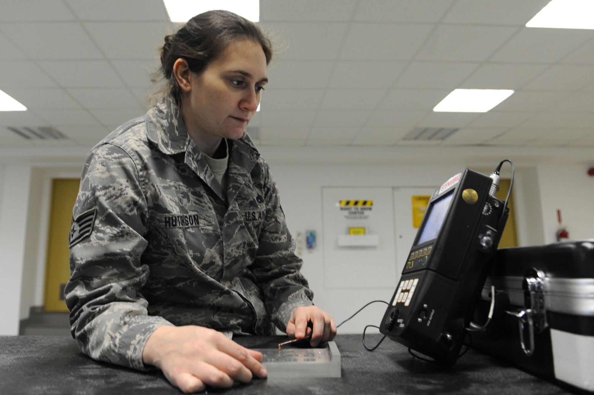 SPANGDAHLEM AIR BASE, Germany – Staff Sgt. Trista Hutchison, 52nd Equipment Maintenance Squadron non destructive inspection craftsman, inspects an aircraft part using circular waves to find minute cracks during an Eddy current inspection here Jan. 25. The NDI lab provides effective test methods to examine the structural integrity of an object or material so that the 52nd Fighter Wing can accomplish its flying mission. (U.S. Air Force photo/Senior Airman Christopher Toon)
