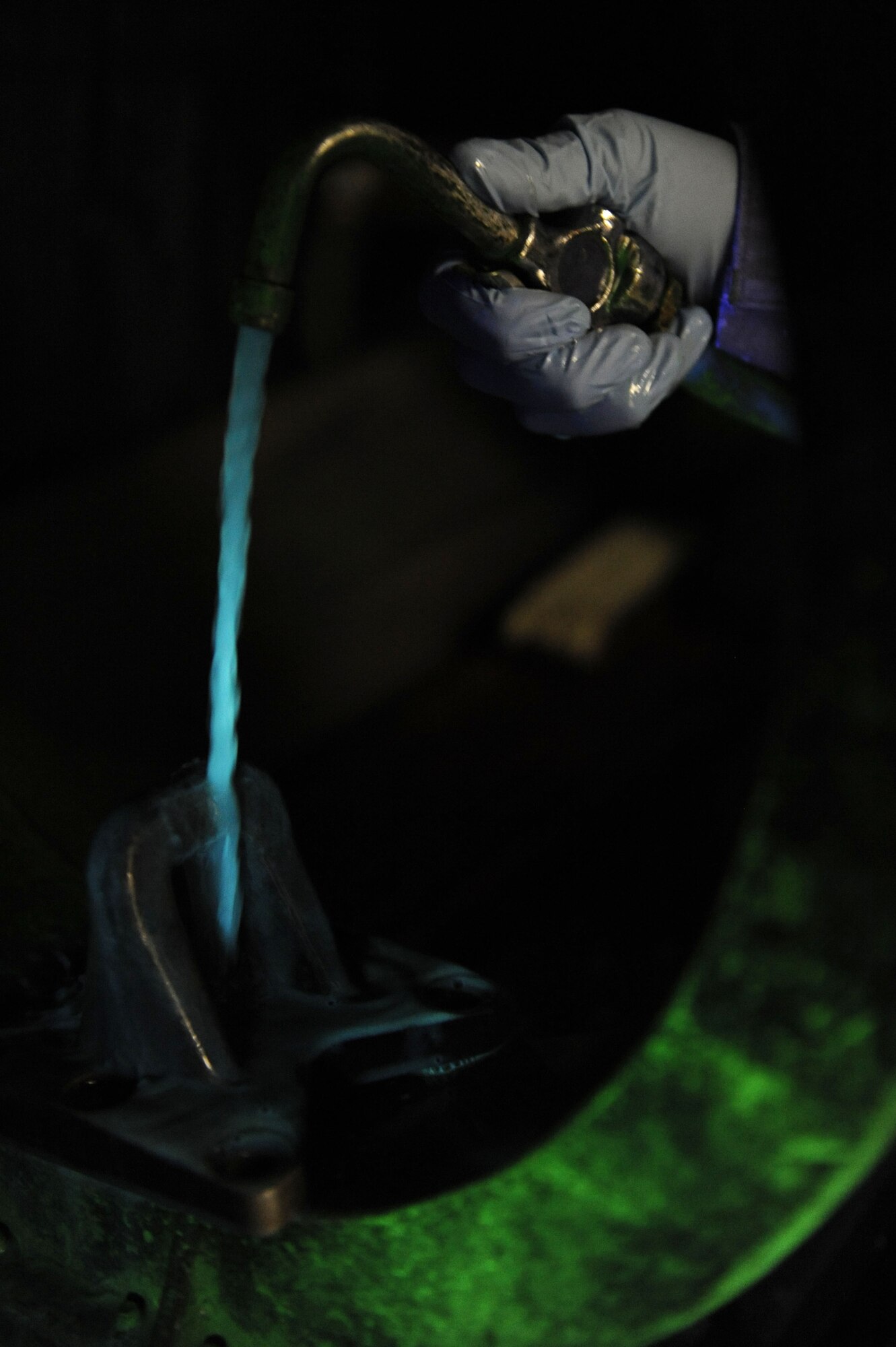 SPANGDAHLEM AIR BASE, Germany – Senior Airman Brigelle Joyner, 52nd Equipment Maintenance Squadron non destructive inspection journeyman, applies a magnetic particle solution fluid to find minute cracks on an aircraft lug part during a magnetic particle inspection here Jan. 25. The NDI lab provides effective test methods to examine the structural integrity of an object or material so that the 52nd Fighter Wing can accomplish its flying mission. (U.S. Air Force photo/Senior Airman Christopher Toon)