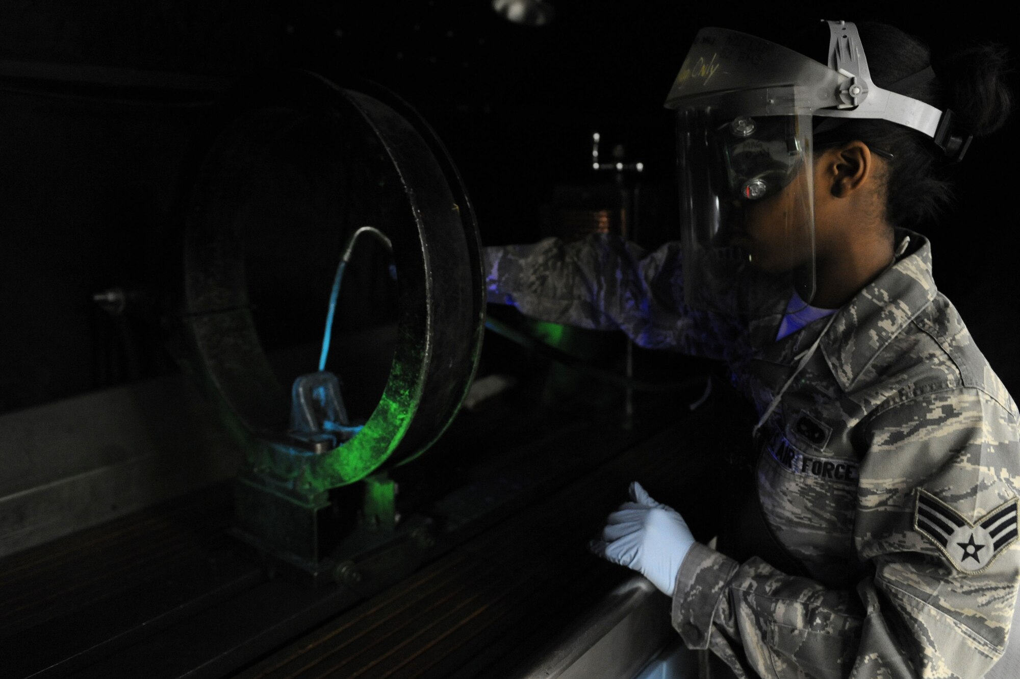 SPANGDAHLEM AIR BASE, Germany – Senior Airman Brigelle Joyner, 52nd Equipment Maintenance Squadron non destructive inspection journeyman, applies a magnetic particle solution fluid to find minute cracks on an aircraft lug part during a magnetic particle inspection here Jan. 25. The NDI lab provides effective test methods to examine the structural integrity of an object or material so that the 52nd Fighter Wing can accomplish its flying mission. (U.S. Air Force photo/Senior Airman Christopher Toon)