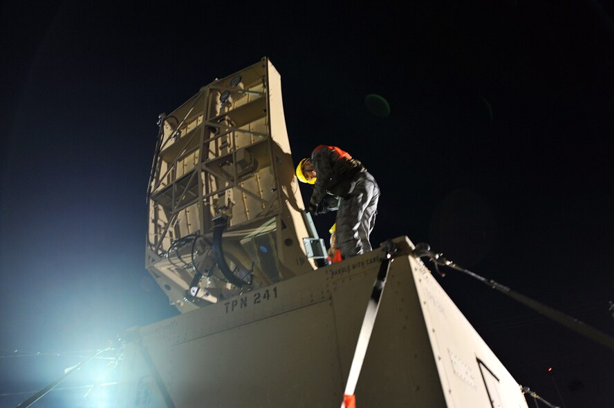 SAVANNAH AIR NATIONAL GUARD BASE, Ga. – Airman 1st Class Dennis Decker, 52nd Combat Communications Squadron ground radar systems apprentice, and Senior Airman Stephen Danko, 52nd CCS ground radar systems journeyman, installs an airport surveillance radar antenna here Jan. 24.  The 52nd began its Arctic Gator field training exercise Jan. 24 and will build, operate in and defend a fully functioning bare base communications camp before the exercise ends Feb. 3. (U.S. Air Force photo by Tommie Horton)