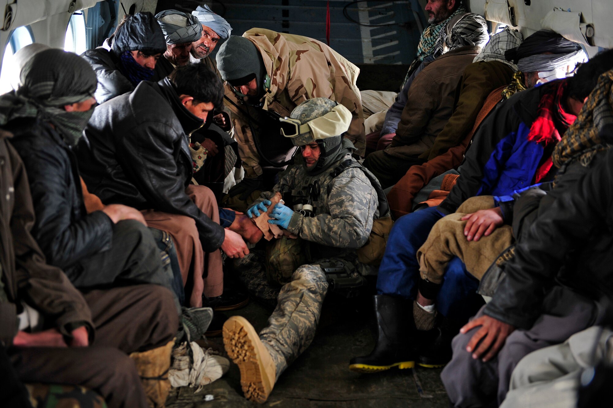 Master Sgt. Chris Banks, a medic with the 438th Air Expeditionary Advisory Group, attends to injured village members on an Mi-17 helicopter Jan 24, 2012. American and Afghan Airmen conducted a rescue mission in Badakshan province; Afghanistan after an avalanche trapped and injured members of Shewa Village. (U.S. Air Force photo/ Master Sgt. Shane A. Cuomo)