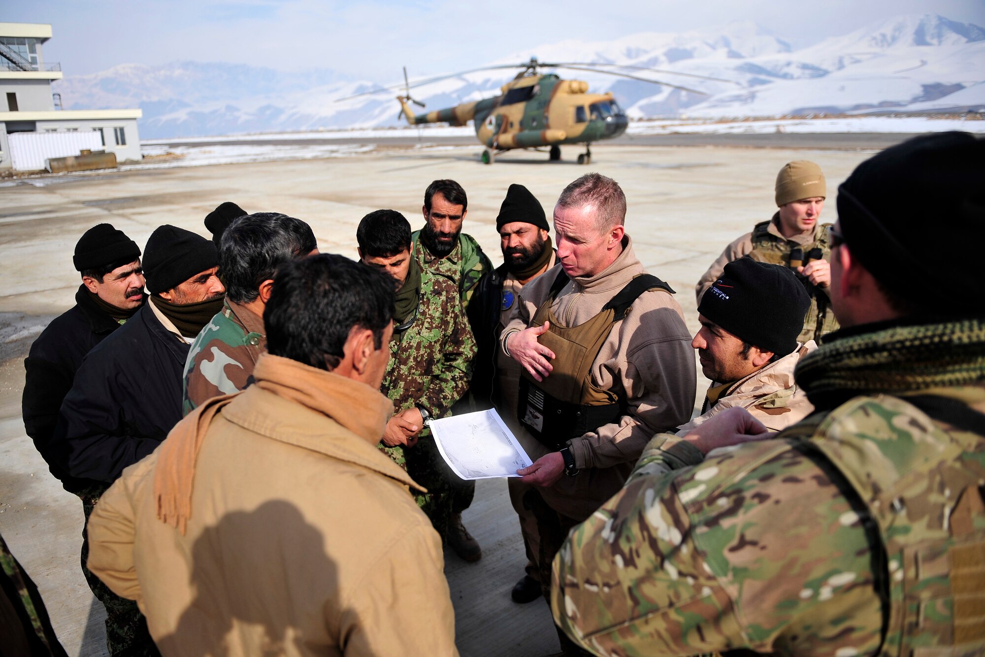 Lt. Col. John Conmy, a Mi-17 helicopter pilot with the 438th Air Expeditionary Advisory Squadron, conducts a pre-flight briefing with his Afghan counterparts at Fayzabad, Badakhshan province, Afghanistan Jan 24, 2012. American and Afghan aircrews are preparing for a rescue mission to evacuate inhabitants that were injured by an avalanche in Shewa village with their Mi-17 helicopters. (U.S. Air Force photo/ Master Sgt. Shane A. Cuomo)