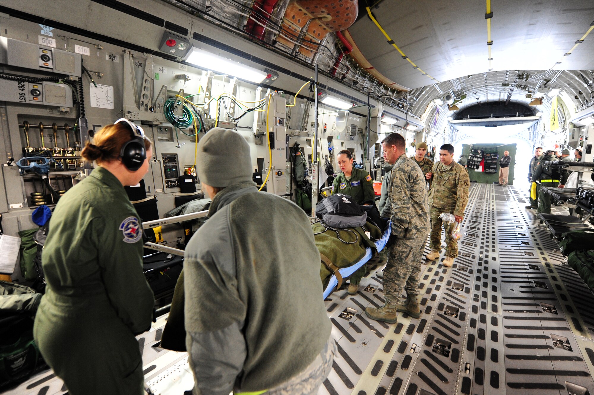 Flight medic’s move wounded warriors off of a C-17 Globemaster III, Ramstein Air Base, Germany, Jan. 25, 2012. The Polish 8th Air Base Aeromedical Evacuation team came to Ramstein to learn how the Contingency Aeromedical Staging Facility personnel move wounded warriors out of the battlefield. (U.S. Air Force photo by Senior Airman Aaron-Forrest Wainwright)
