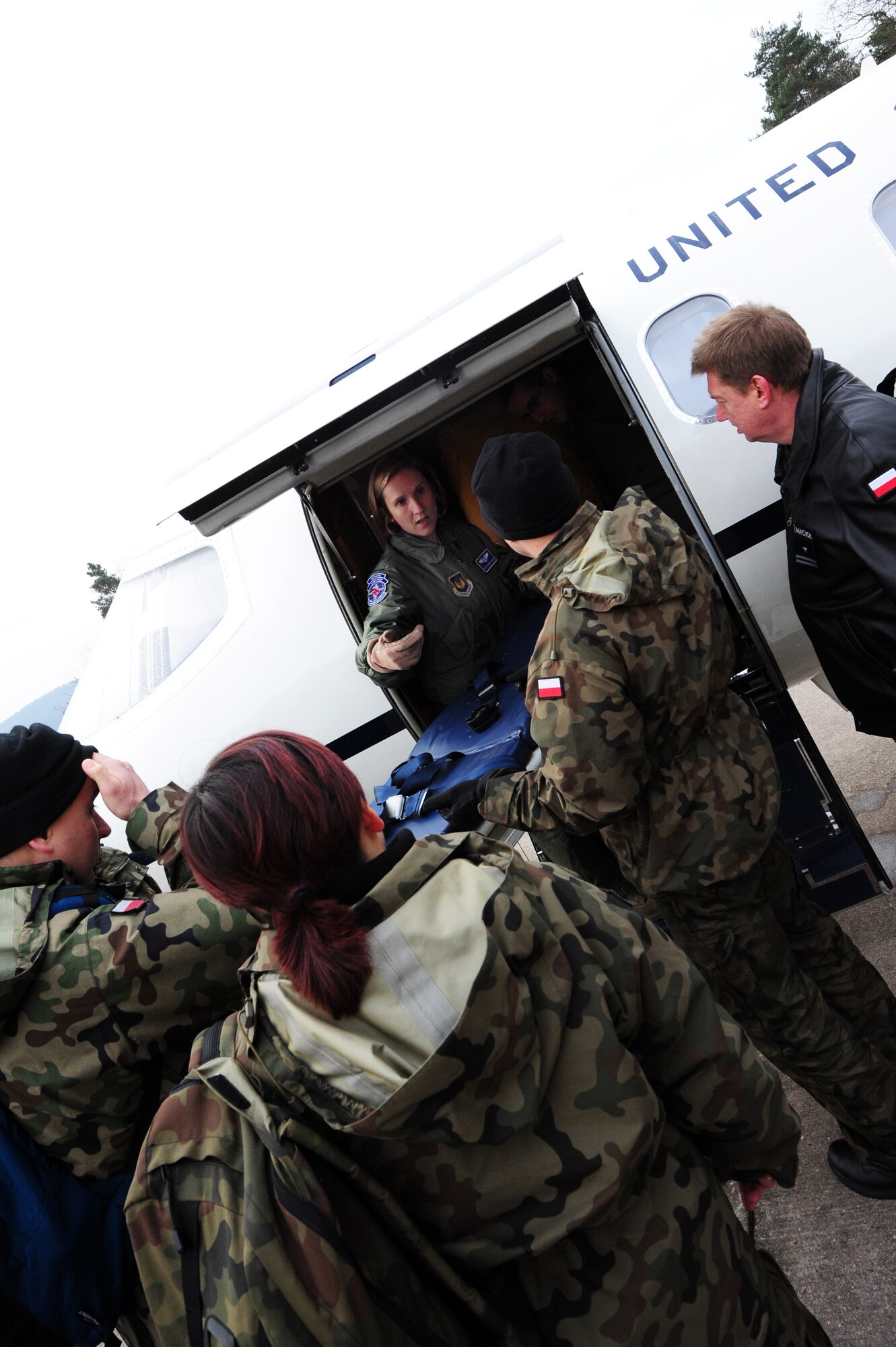 Tech Sgt. Elizabeth Araujo, 86th Aeromedical Evacuation Squadron aeromedical evacuation technician, demonstrates to the Polish 8th Air Base Aeromedical Evacuation team, how to load patients on the C-21 in it’s Aeromedical Evacuation configuration, Ramstein Air Base, Germany, Jan. 25, 2012. The tour included visits to see a C-21 in its AE configuration, observe patients loaded onto a C-17 Globemaster III, a visit to the Landstuhl Regional Medical Center and an AE flight training mission. (U.S. Air Force photo by Senior Airman Aaron-Forrest wainwright)