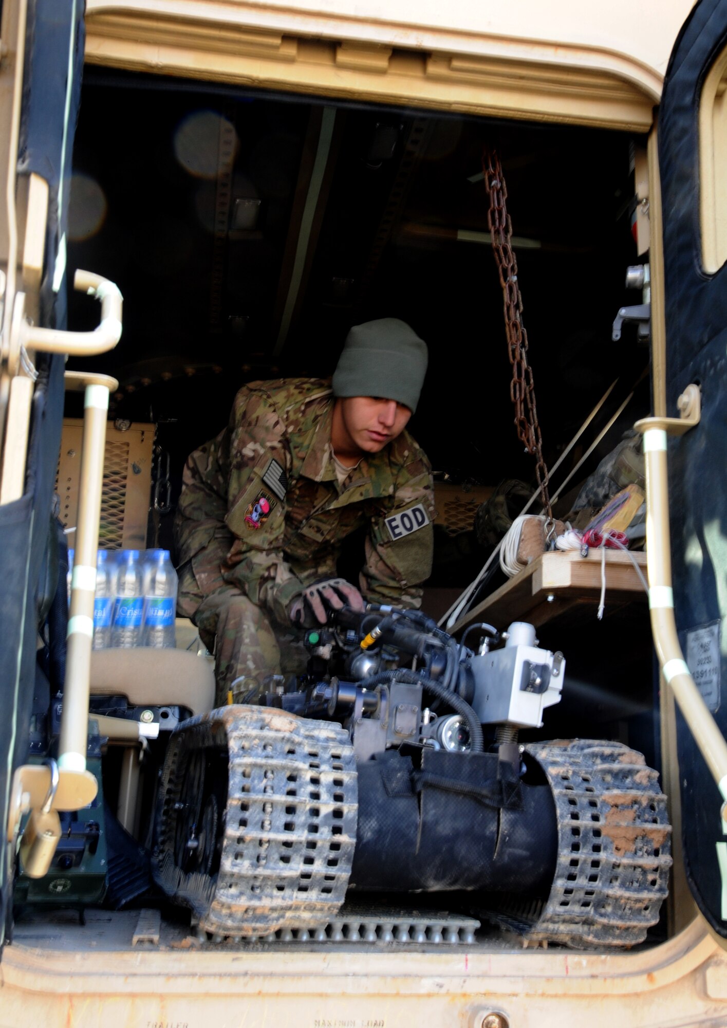 MAIN OPERATING BASE LEATHERNECK, Afghanistan -- Airman 1st Class Seth Reinhart, an Explosive Ordnance Disposal technician from the 466th EOD Flight, Operating Location-Delta, pushes a robot from his team’s armored truck so they can train for a mission. The robot is used by the EOD team to get close to suspected Improvised Explosive Devices while they stay protected in an armored vehicle. The mission of the Airmen of OL-D is primarily focused on countering the IED threat, destroying enemy caches and munitions stockpiles, and responding to threats of indirect fire. (U.S. Air Force photo/Senior Airman Tyler Placie)
