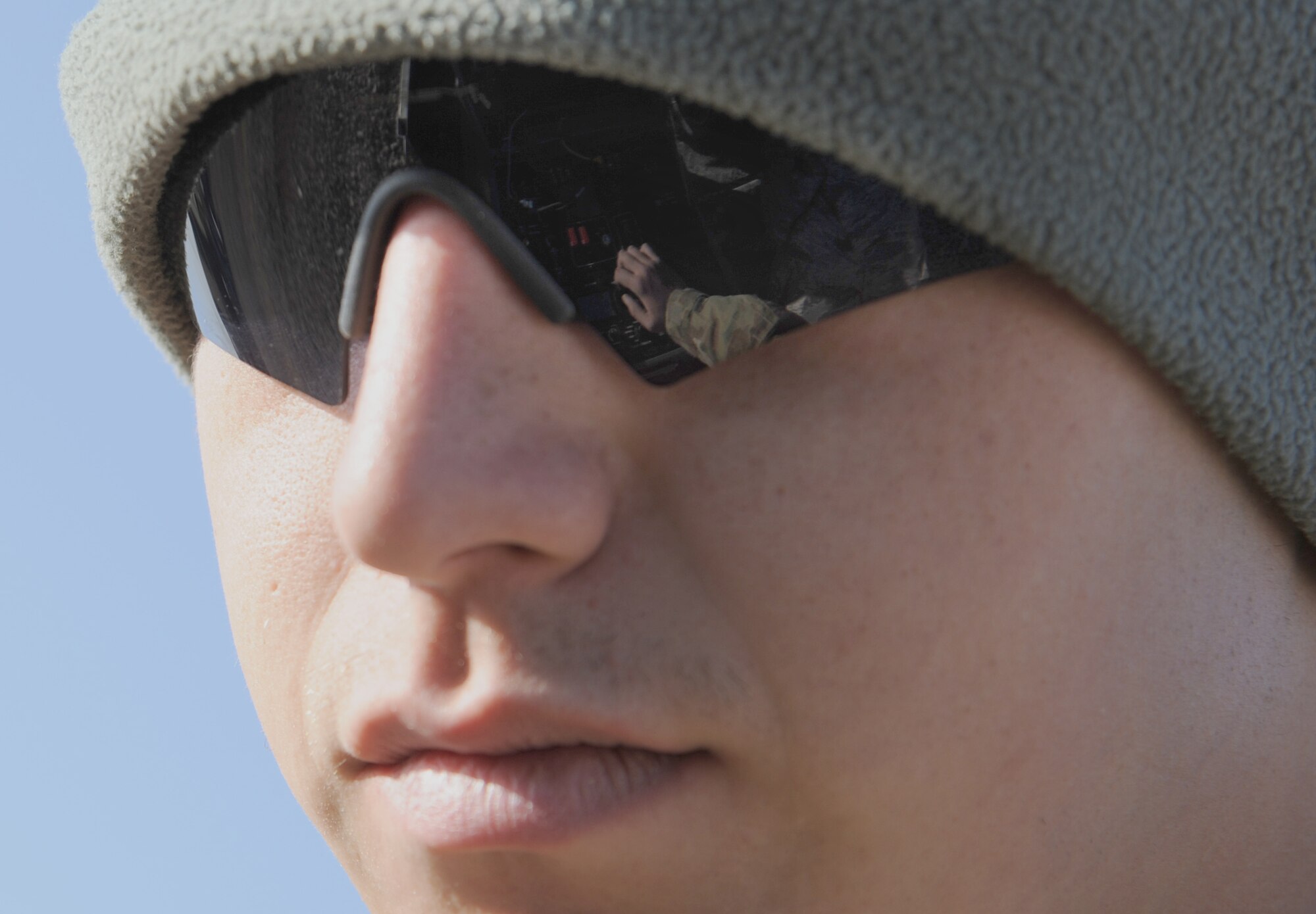 MAIN OPERATING BASE LEATHERNECK, Afghanistan -- A reflection in the sunglasses of Airman 1st Class Seth Reinhart, an Explosive Ordnance Disposal technician from the 466th EOD Flight, Operating Location-Delta, shows his hand as he trains for a mission using a computer that controls a robot. The robot allows his EOD team to get close to suspected Improvised Explosive Devices while they stay protected in an armored vehicle. The mission of the Airmen of OL-D is primarily focused on countering the IED threat, destroying enemy caches and munitions stockpiles, and responding to threats of indirect fire. (U.S. Air Force photo/Senior Airman Tyler Placie)