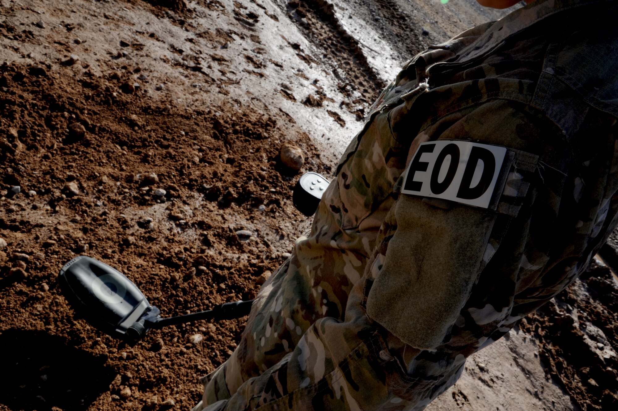 MAIN OPERATING BASE LEATHERNECK, Afghanistan -- An Explosive Ordnance Disposal technician from the 466th EOD Flight, Operating Location-Delta, trains for a mission using a specialized metal detector that can find material underground that may be used in an Improvised Explosive Device. The mission of the Airmen of OL-D is primarily focused on countering the IED threat, destroying enemy caches and munitions stockpiles, and responding to threats of indirect fire. (U.S. Air Force photo/Senior Airman Tyler Placie)