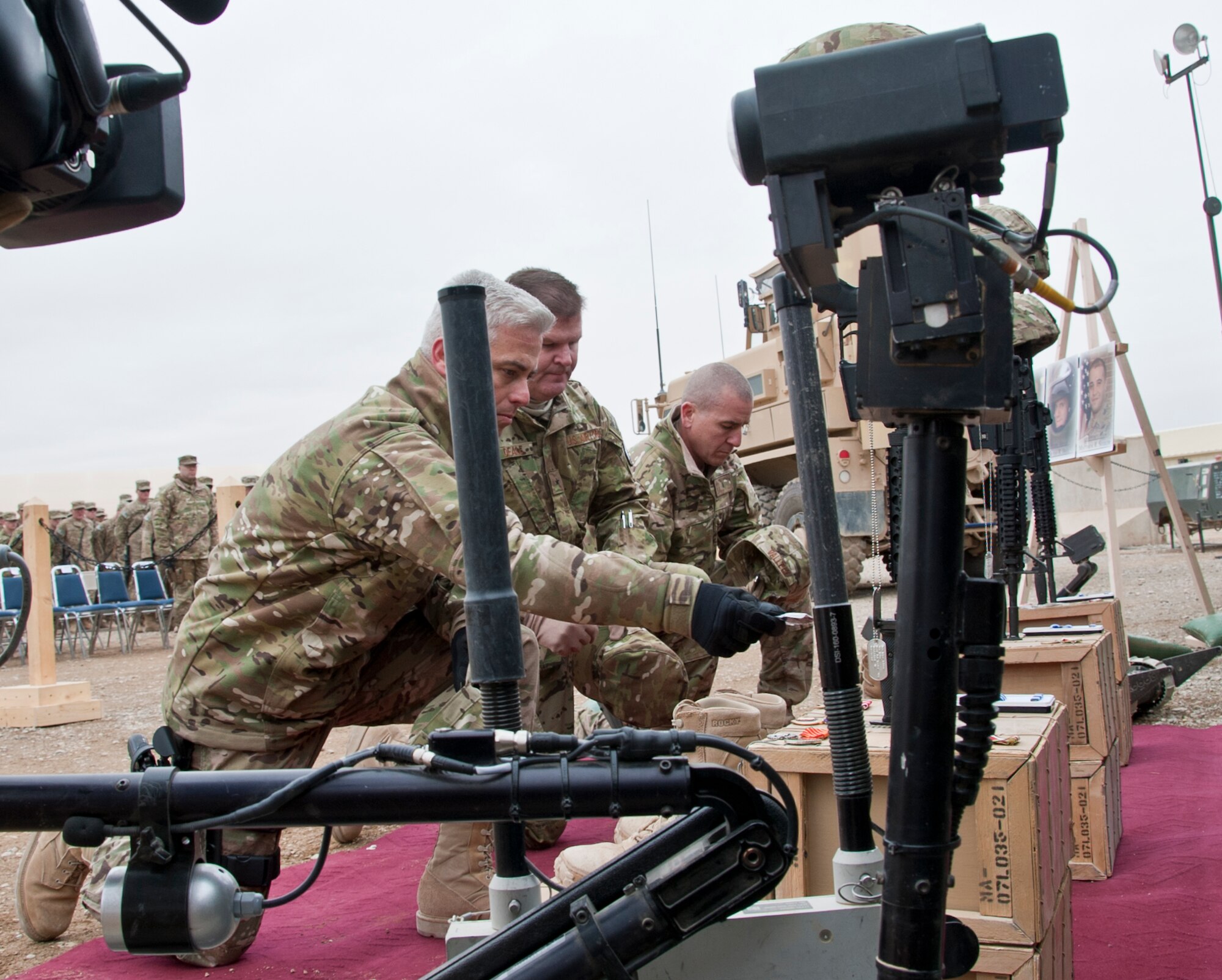 CAMP LEATHERNECK, Afghanistan -- From left, Chief Master Sgt. Robert Sealey, Air Forces Central command chief; Brig. Gen. Thomas Deale, 451st Air Expeditionary Wing commander; and Chief Master Sgt. Thomas Vallely, 451st AEW command chief, render salutes to the Battle Crosses of three fallen Airmen during a memorial ceremony at Camp Leatherneck, Afghanistan Jan. 24, 2012. The three Airmen were explosive ordnance disposal technicians who were killed Jan. 5 by an improvised explosive device in Shir ghazi, Helmand province, Afghanistan. (U.S. Air Force photo by Staff Sgt. David Carbajal)