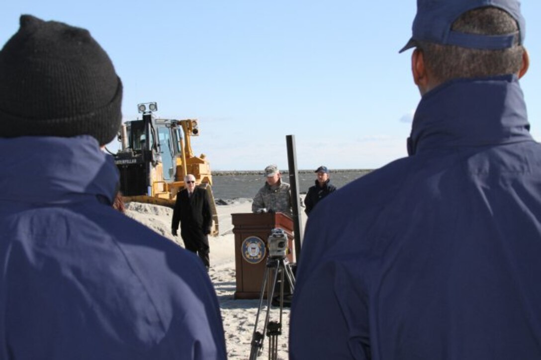 Lt. Col. Philip M. Secrist, U.S. Army Corps of Engineers Philadelphia district commander, speaks about the beach nourishment project as two U.S. Coastguardsmen look on. The $9 million project placed about 600,000 cubic yards of sand onto the beach.