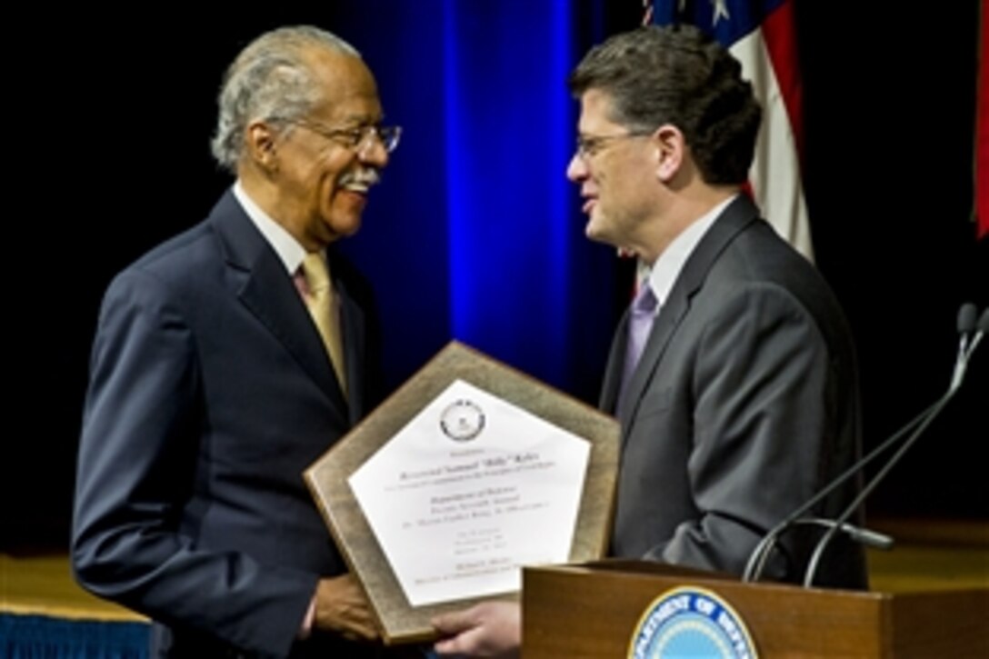 Michael L. Rhodes, Defense Department director of administration and management, right, presents Rev. Samuel "Billy" Kyles with a commemorative plaque after speaking at the 27th annual ceremony to honor Martin Luther King Jr. at the Pentagon, Jan. 26, 2012. 