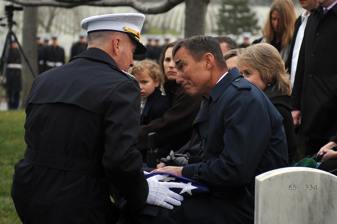 Gen. Joseph F. Dunford Jr., assistant commandant of the Marine Corps, presents a folded flag to Michael Jaskilka during his father’s funeral service at Arlington National Cemetery Jan. 26. Gen. Samuel Jaskilka (1919-2012) joined the Marine Corps reserves as a second lieutenant in 1942 and served as the 16th assistant commandant from 1975 until he retired in 1978. Jaskilka was also honored with a flyover of four MV-22 Ospreys during the ceremony. Jaskilka’s awards include the Navy Distinguished Service Medal, two Silver Star Medals, a Legion of Merit, a Bronze Star Medal with a valor device, a World War II Victory Medal, seven Vietnam Service Medals and a United Nations Korea Medal.::r::::n::