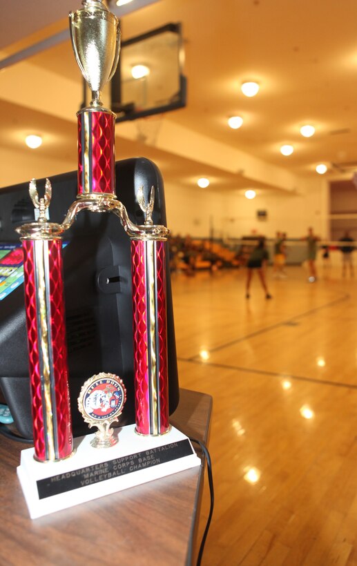 A championship trophy sits next to the score board during the volleyball Headquarters and Support Battalion Commander's Cup Challenge, held at the Area 1 Gym aboard Marine Corps Base Camp Lejeune, Jan. 27. The next competition will be an indoor dodgeball tournament scheduled for Feb. 24.