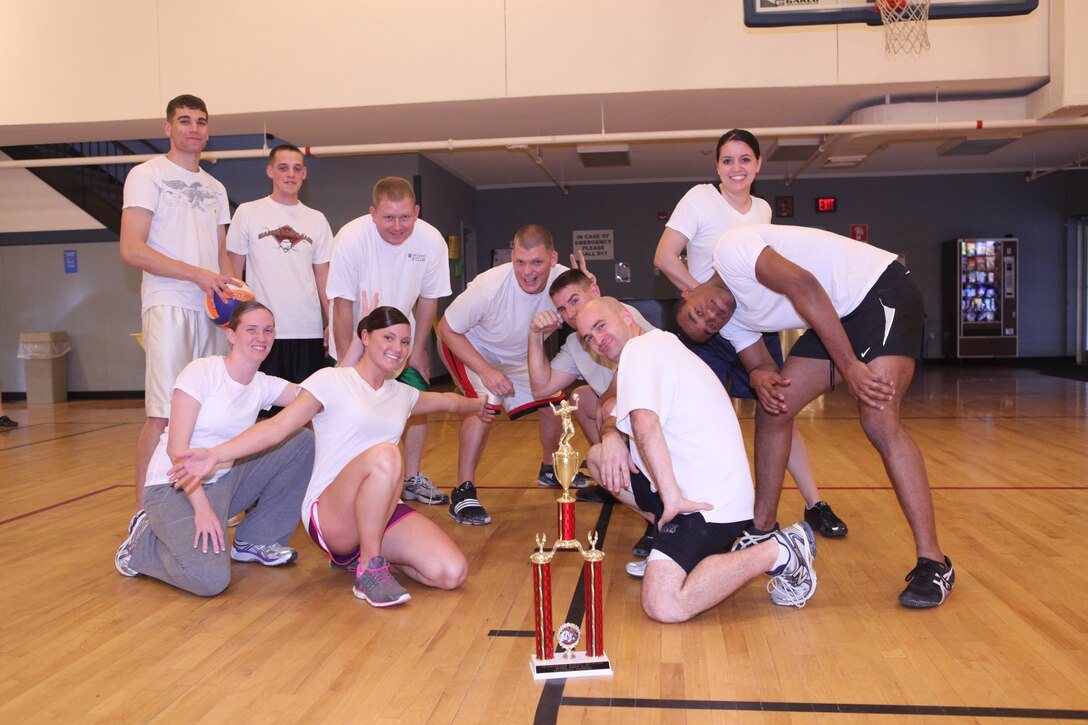 Marines with Company A, Headquarters and Support Battalion, Marine Corps Base Camp Lejeune gather around the trophy after winning the indoor volleyball HQSPTBn. Commander’s Cup Challenge, held at the Area 1 Gym aboard MCB Camp Lejeune, Jan. 27. The next competition will be an indoor dodgeball tournament scheduled for Feb. 24.