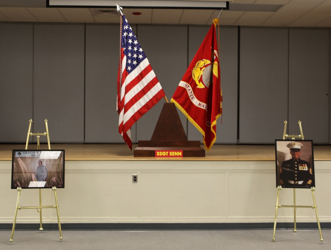 Flags and pictures of Staff Sgt. Jimmie Senn adorn the stage during his memorial service at Camp Johnson, N.C. Jan. 27.  Senn was a medium tactical vehicle replacement instructor with Marine Corps Combat Support School. He was in the Marine Corps for 16 years and served through several deployments.