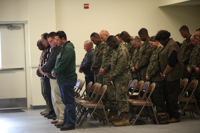 Guests to Staff Sgt. Jimmie Senn’s memorial service pray at Camp Johnson, N.C. Jan 27. Senn was a medium tactical vehicle replacement instructor with Marine Corps Combat Support School.  He was a family man who enjoyed fishing, football, and barbecues.