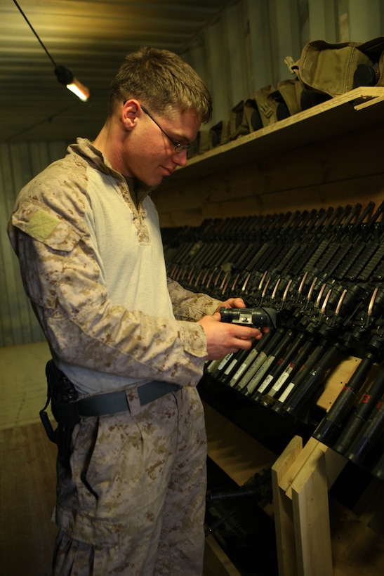 Cpl. Joseph Schank, a small arms repair technician with Marine Air-Ground Task Force Support Battalion 11.2, 2nd Marine Logistics Group (Forward), organizes night vision goggles inside his workplace aboard Camp Leatherneck, Afghanistan, Jan. 27. Schank was able to watch his second child’s birth while deployed in Afghanistan via video chat the day prior. (U.S. Marine Corps photo by Cpl. Katherine M. Solano)