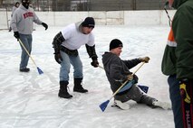 Sgt. Jacob Bucinski, Recruiting Substation Rochester, sneaks a backwards pass around Sgt. Joshua Draveling, Recruiting Substation Burnsville, during the 2012 Recruiting Station Twin Cities broom ball tournament Jan. 27. For additional imagery from the event, visit www.facebook.com/rstwincities.
