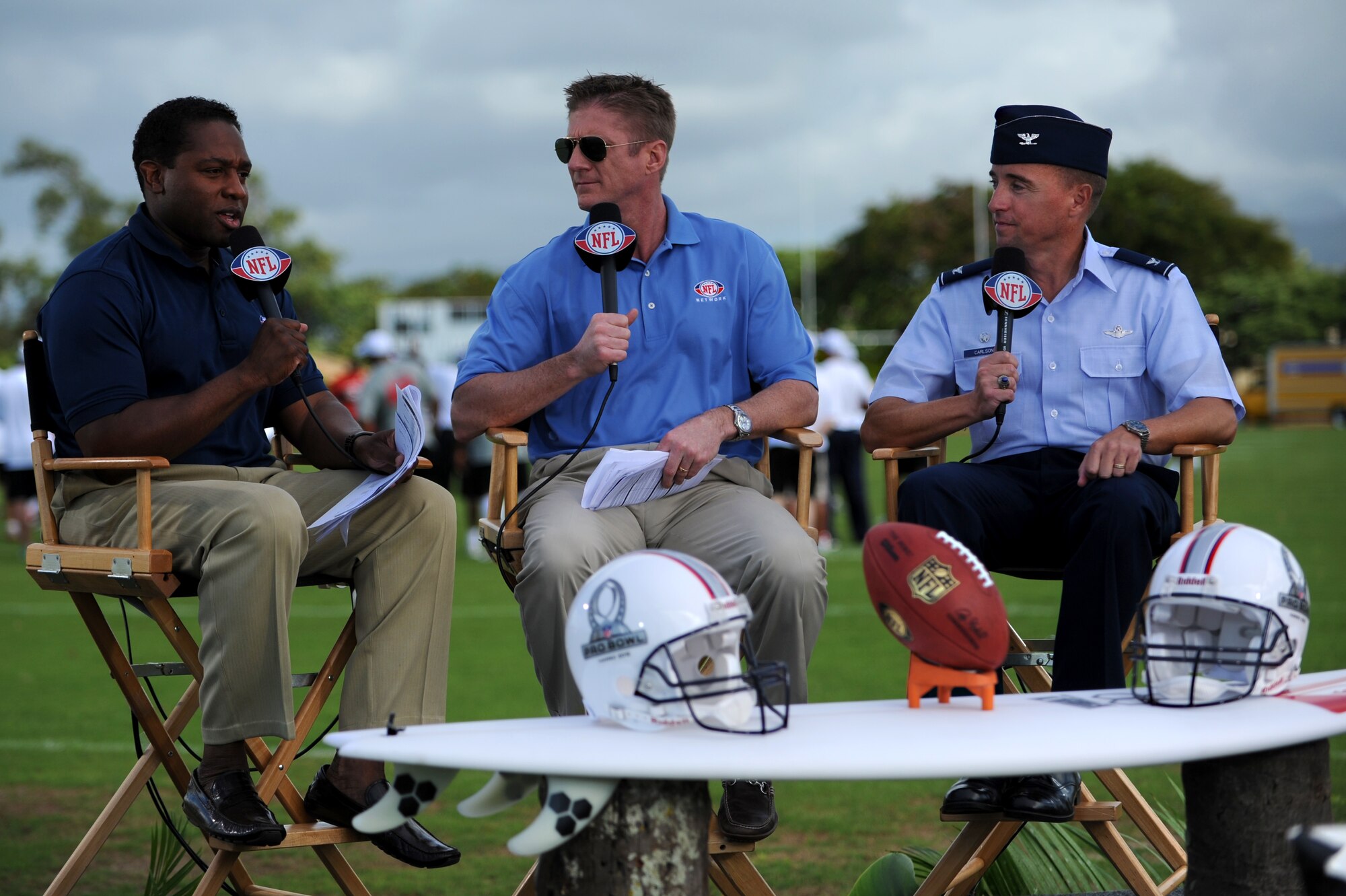 Fran Charles and Tom Waddle, NFL Network analysts, interviews Col. Dann Carlson, 647th Air Base Group commander and Joint Base Pearl Harbor-Hickam deputy commander, during the Pro Bowl practice sessions at Earhart Field Jan. 26. (U.S. Air Force photo/Staff Sgt. Mike Meares)