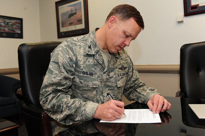 U.S. Air Force Col. Steven Garland, 99th Air Base Wing commander, signs the official proclamation kicking off the Air Force Assistance Fund campaign for the installation Jan. 26, 2012, at Nellis Air Force Base, Nev. The AFAF is an annual campaign to raise funds for four charitable affiliates that provide support to Air Force families in need.  In 2011, Nellis AFB, Creech AFB, and Nevada Test and Training Range Airmen, retirees and families received more support from these four organizations than any other installation across the Air Force, totaling more than $726,000 in much appreciated aid.  (U.S. Air Force photo by Staff Sgt. William P.Coleman)
