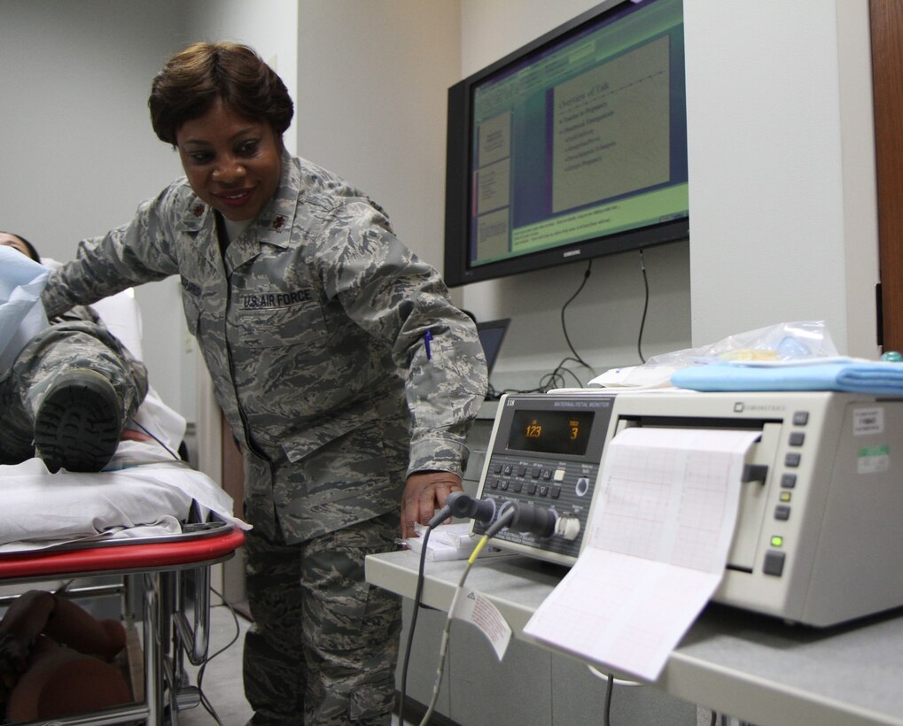 Maj. Patricia Edwards-Parrish checks the readings on a fetal monitor while holding a portable sensor on her patient.  Edwards-Parrish is assigned to the 932nd Medical Squadron, which conducted a series of proficiency training sessions during the January weekend drill.  Air Force Reserve nurses and medical technicians possess a broad range of medical skills.  The  training 932nd MDS members undergo periodically ensures they're prepared for annual tour  or duty in a deployed location. (U.S. Air Force photo/Tech. Sgt. Christopher Parr) 