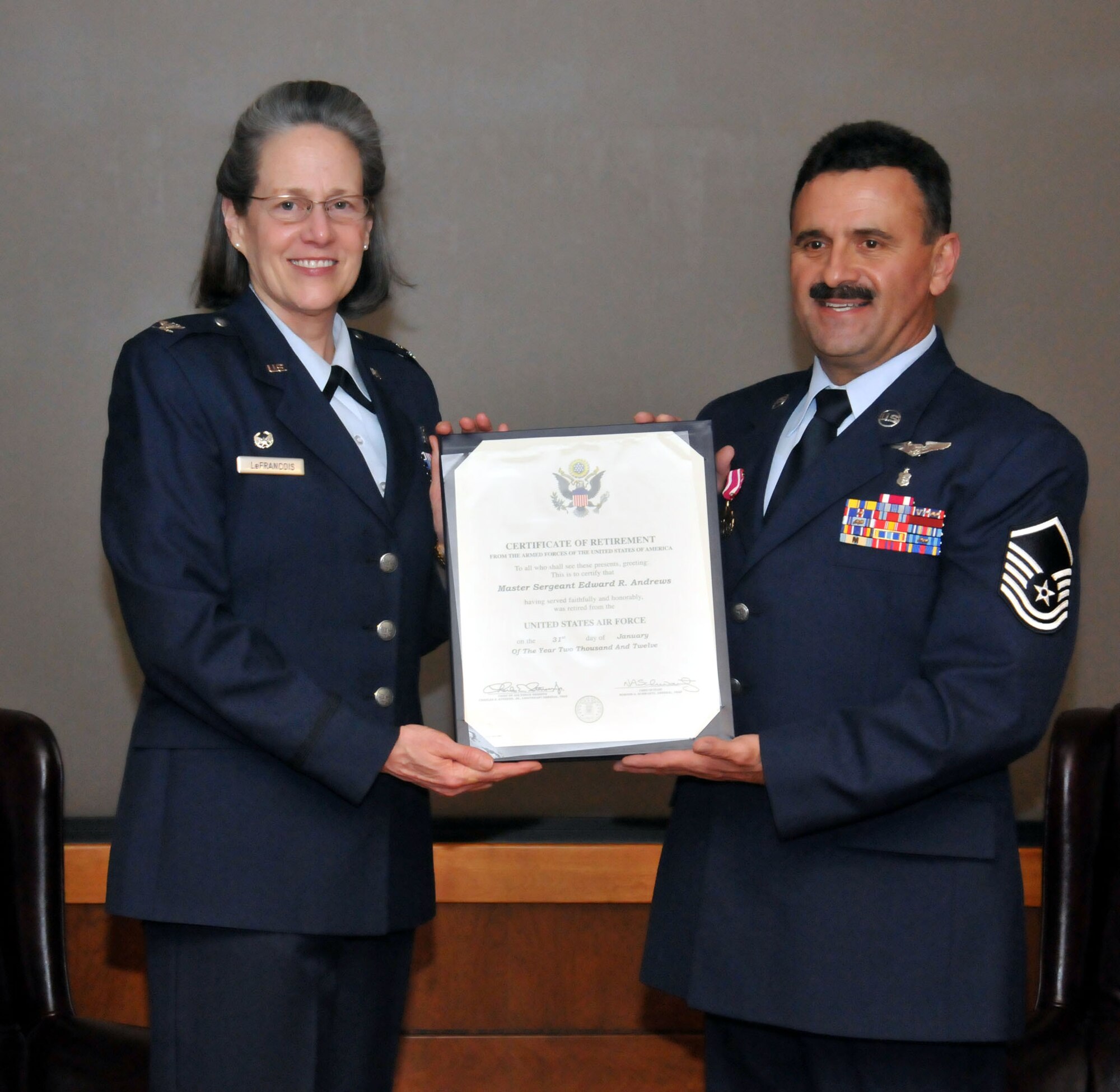 TRAVIS AIR FORCE BASE, Calif. -- Col. Terese D. LeFrancois, Commander, 349th Aerospace Medicine Squadron, presents Master Sgt. Edward R. Andrews, with his retirement certificate during a ceremony, here, Jan. 22. (U.S. Air Force photo / Master Sgt. Robert Wade) 