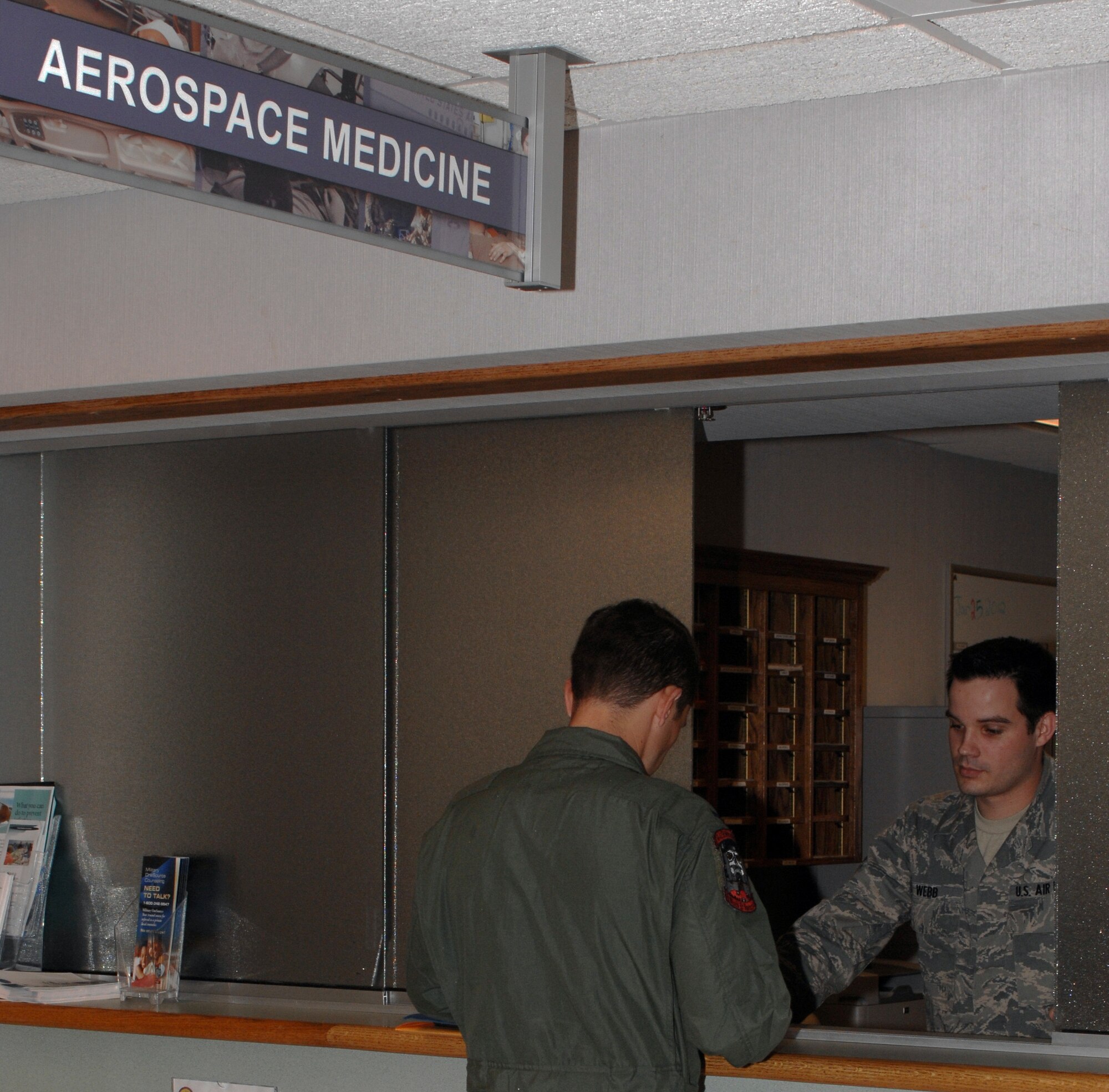 1st Lt. Bryan Freeman, 11th Bomb Squadron pilot, finishes paperwork to give to Airman 1st Class Paul Webb, 2nd Aerospace Medical Squadron medical technician, at the Clinic on Barksdale Air Force Base, La., Jan. 25. Freeman was scheduled for his annual check to maintain his flying status. (U.S. Air Force photo/Airman 1st Class Joseph A. Pagán Jr.)(RELEASED)