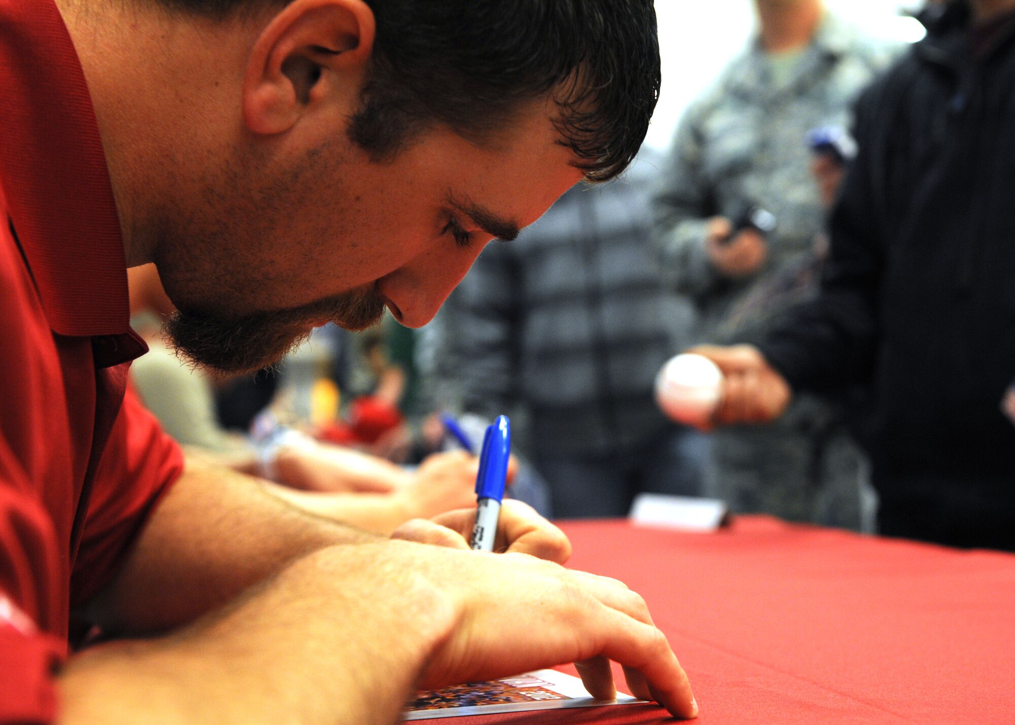 Texas Rangers’ Michael Kirkman, pitcher, autographs photos during a base tour, Jan. 25, 2012, at Dyess Air Force Base, Texas. The Rangers visit multiple bases in Texas annually to sign autographs and meet military personnel. (U.S. Air Force photo by Airman 1st Class Jonathan Stefanko/Released)