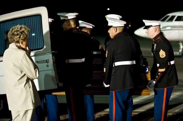 A Marine Corps weapons platoon loads U.S. Marine Corps Cpl. Jon-Luke Bateman's casket into a hearse during his dignified arrival Jan. 25, 2012, on the flightline at Nellis Air Force Base, Nev. Bateman, 22, of Pahrump, Nev., was an infantryman assigned to 2nd Battalion, 4th Marines, 1st Marine Division, Camp Pendleton, Calif. He was killed while serving his second combat deployment. (U.S. Air Force photo by Senior Airman Brett Clashman)