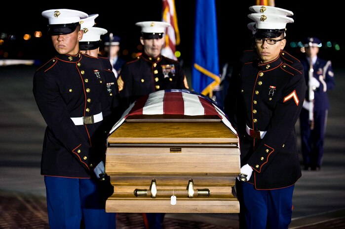 A Marine Corps weapons platoon carries U.S. Marine Corps Cpl. Jon-Luke Bateman's casket during his dignified arrival Jan. 25, 2012, on the flightline at Nellis Air Force Base, Nev. Bateman, 22, of Pahrump, Nev., was an infantryman assigned to 2nd Battalion, 4th Marines, 1st Marine Division, Camp Pendleton, Calif. He was killed while serving his second combat deployment. (U.S. Air Force photo by Senior Airman Brett Clashman)

