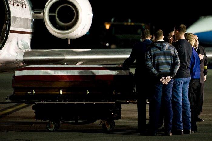 Family members of U.S. Marine Corps Cpl. Jon-Luke Bateman take a moment to grieve during his  dignified arrival Jan. 25, 2012, on the flightline at Nellis Air Force Base, Nev. Bateman, 22, of Pahrump, Nev., was an infantryman assigned to 2nd Battalion, 4th Marines, 1st Marine Division, Camp Pendleton, Calif. He was killed while serving his second combat deployment.  (U.S. Air Force photo by Senior Airman Brett Clashman)