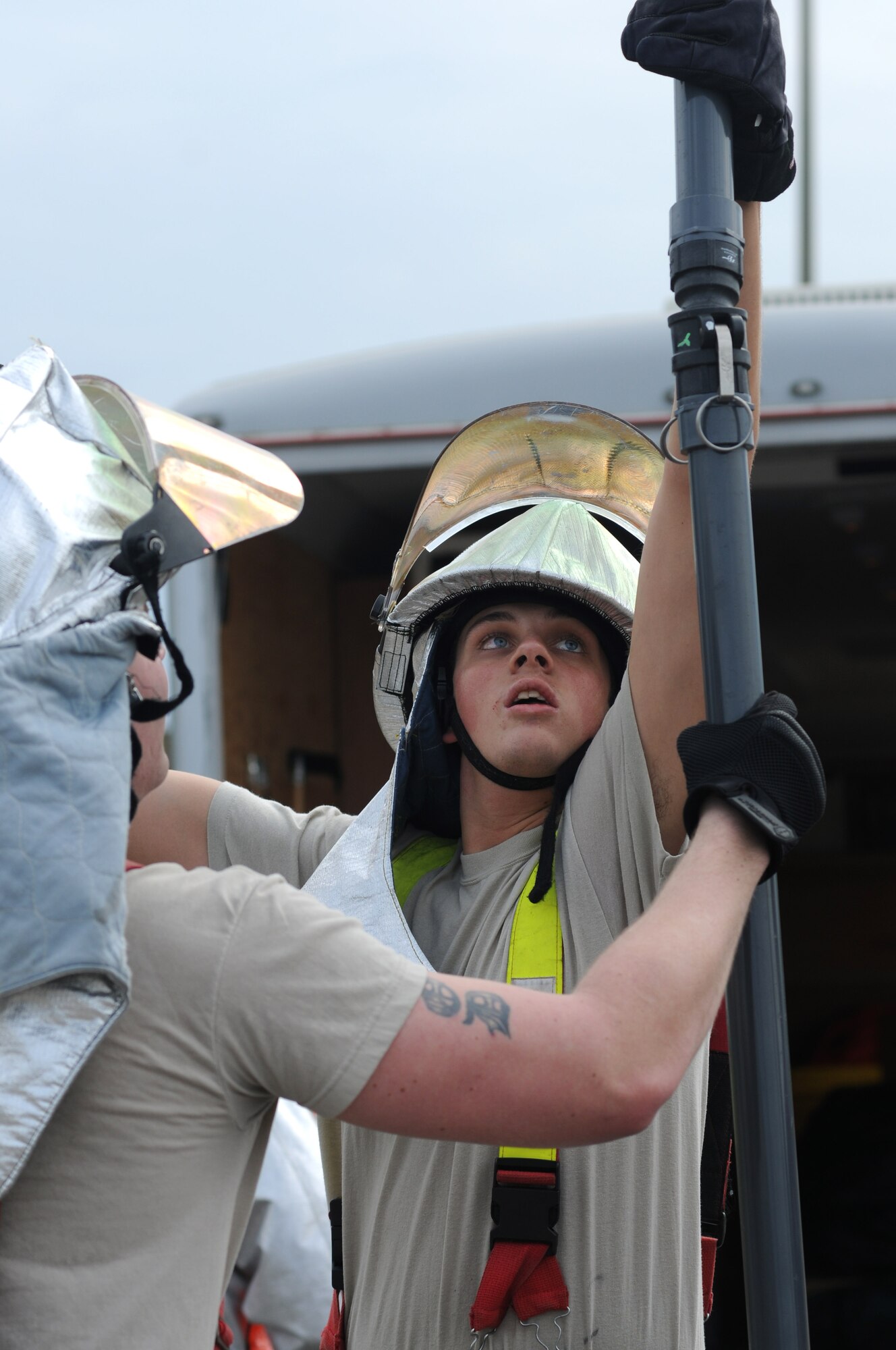 Airman 1st Class Nicholas Durkin, and Senior Airman John Hood, Keesler Fire Department, deploy equipment and assemble HAZMAT equipment for decontamination site during a Chemical, Biological, Radiological, Nuclear, and high-yield Explosive exercise scenario Jan. 26, 2012, at Keesler Air Force Base, Miss. The Force Protection Condition exercise scenario included a terrorist group that was able to penetrate the base and park a truck with a four, hundred-gallon barrels full of anhydrous ammonia by the soccer field on G Street.  A small improvised explosive device was “exploded” causing the anhydrous ammonia to pour from the trailer, exposing a group of ten Airmen who had just finished physical training.  Immediately the Airmen simulated receiving skin and eye irritations and burns, coughing, chest pain and vomiting from exposure to the chemical.  Two Airmen also simulated receiving broken bones from flying debris from the explosion.   Also the 81st Medical Group and 81st Security Forces Squadron responded on scene.  The exercise took place Jan. 23-27.  (U.S. Air Force photo by Kemberly Groue)