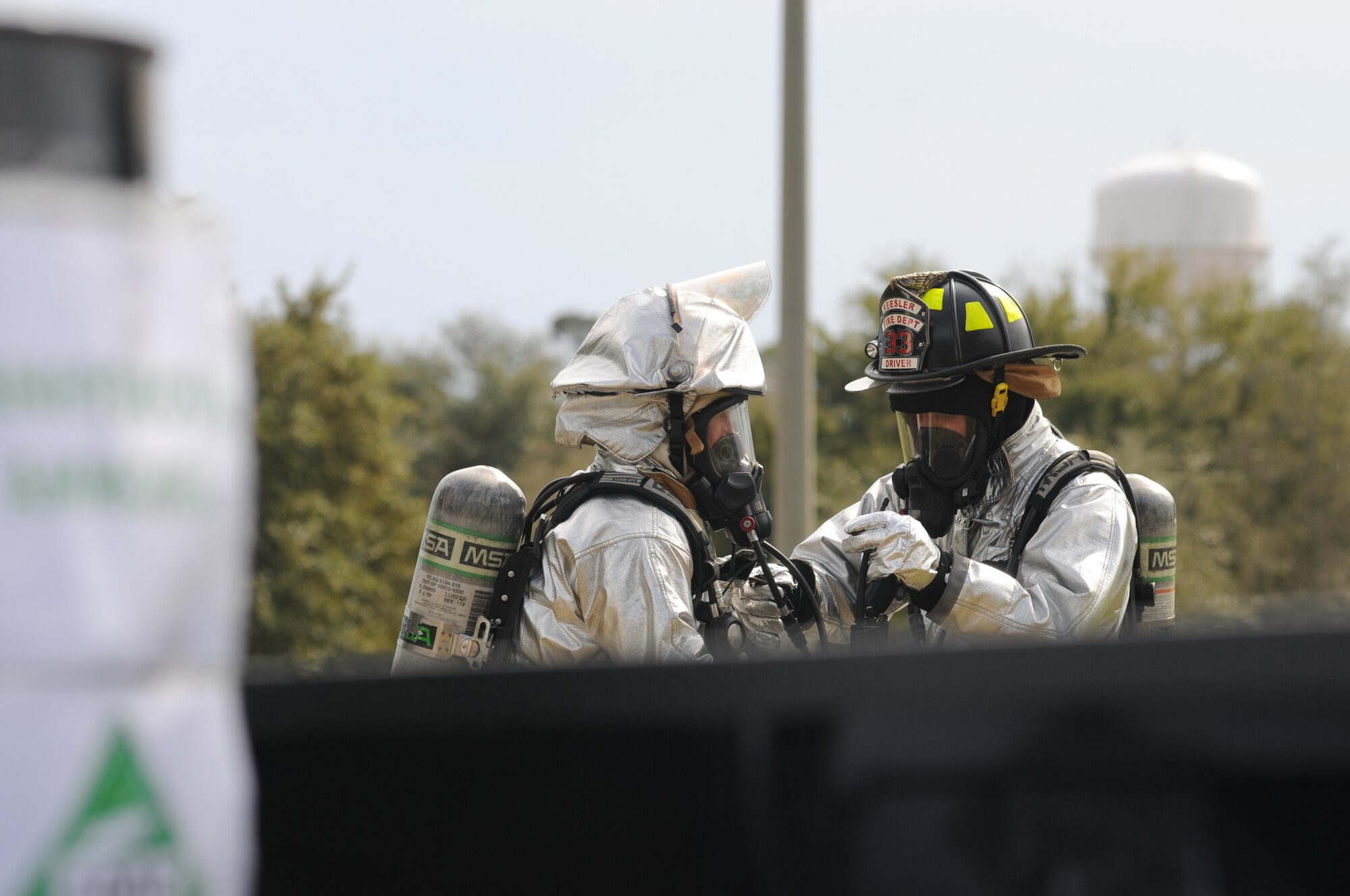 Keesler Firefighters respond to a Chemical, Biological, Radiological, Nuclear, and high-yield Explosive exercise scenario Jan. 26, 2012, at Keesler Air Force Base, Miss.  The Force Protection Condition exercise scenario included a terrorist group that was able to penetrate the base and park a truck with a four, hundred-gallon barrels full of anhydrous ammonia by the soccer field on G Street.  A small improvised explosive device was “exploded” causing the anhydrous ammonia to pour from the trailer, exposing a group of ten Airmen who had just finished physical training.  Immediately the Airmen simulated receiving skin and eye irritations and burns, coughing, chest pain and vomiting from exposure to the chemical.  Two Airmen also simulated receiving broken bones from flying debris from the explosion.   Also the 81st Medical Group and 81st Security Forces Squadron responded on scene.  The exercise took place Jan. 23-27.  (U.S. Air Force photo by Kemberly Groue)
