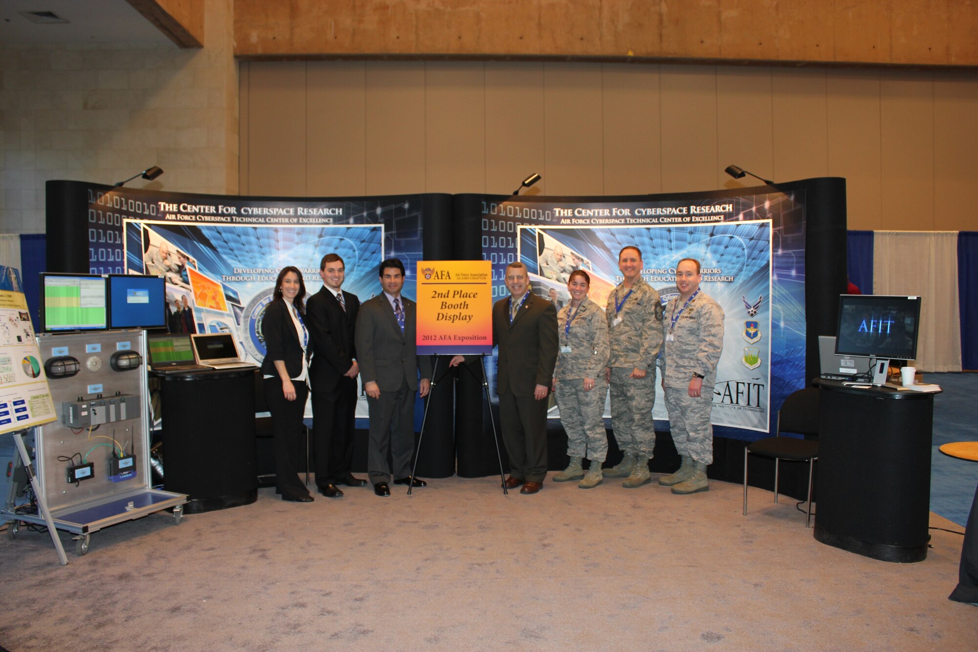 Center for Cyber Research faculty and staff members attended the 2012 AETC Symposium in San Antonio, TX January 12-13 at the Henry B. Gonzalez Conference Center. CCR won 2nd
place "Booth Display" presented by the Air Force Association, Alamo Chapter, the exhibition's host.  CCR members attending the AETC Symposium included (left to right) Carrie Solberg, Eric Lapse, Juan Lopez, Jr., Dr. Harold Arata, Lt Nina Weissgerber, CMSgt Michael Woelfle, and Maj Thomas Dube. (U.S. Air Force photo)

