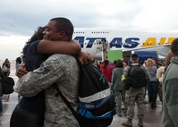 Senior Airman James Taylor, 28th Aircraft Maintenance Squadron weapons journeyman, embraces Senior Airman Ebony Nelson, Air Force Financial Services Center finance technician, during the homecoming event on Ellsworth Air Force Base, S.D., Jan. 25, 2012. Ellsworth Airmen returned from a six-month deployment to Southwest Asia where they were essential in providing critical air presence, surveillance and reconnaissance. (U.S. Air Force photo by Airman Alystria Maurer/Released)