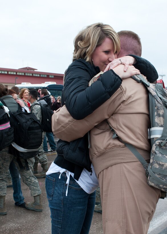 Capt. Amanda Finnegan, 28th Bomb Wing plans and programs officer, welcomes home her husband, Capt. Marc Finnegan, 34th Bomb Squadron unit deployment manager, returning from a six-month deployment from Southwest Asia during the homecoming even on Ellsworth Air Force Base, S.D., Jan. 25, 2012. Base aircrews responded to more than 432 troops-in-contact situations and destroyed more than 320 enemy targets. (U.S. Air Force photo by Airman Alystria Maurer/Released)